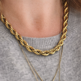 Skye and Rocket Isabella thick gold rope chain necklace on a person wearing a gray sweater